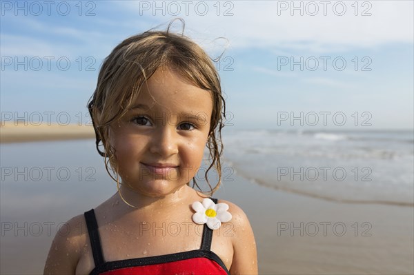 Mixed race girl smiling on beach