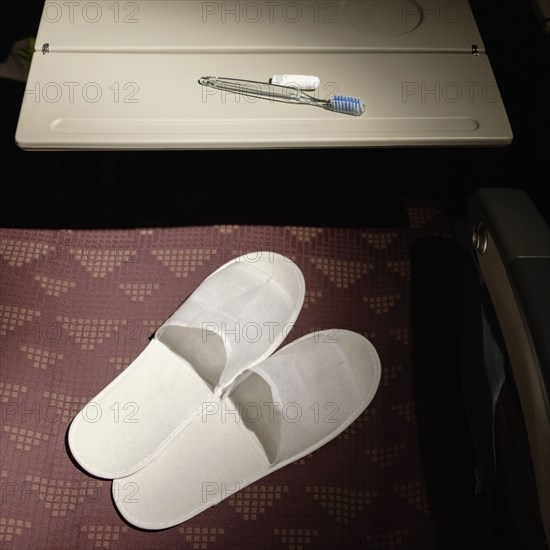 Slippers and toothbrush in airplane seat