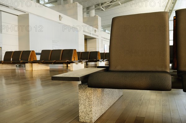 Empty chairs in airport waiting area