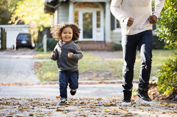 Father and son playing in driveway