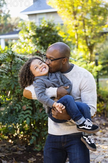 Father kissing son outdoors