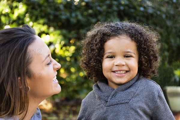 Mother and son smiling outdoors