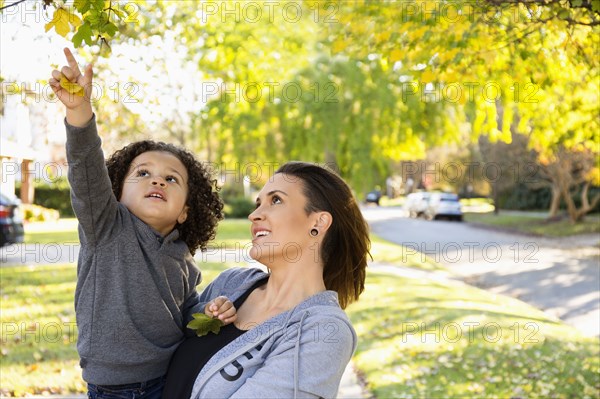 Mother and son admiring tree outdoors