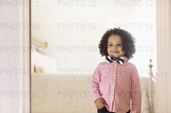 Smiling mixed race boy wearing bow tie