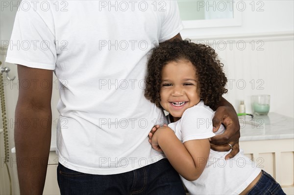 Father and son hugging in bathroom