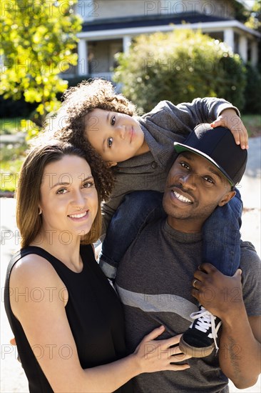 Family smiling outdoors