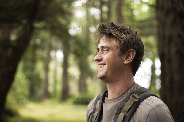 Caucasian man smiling in forest