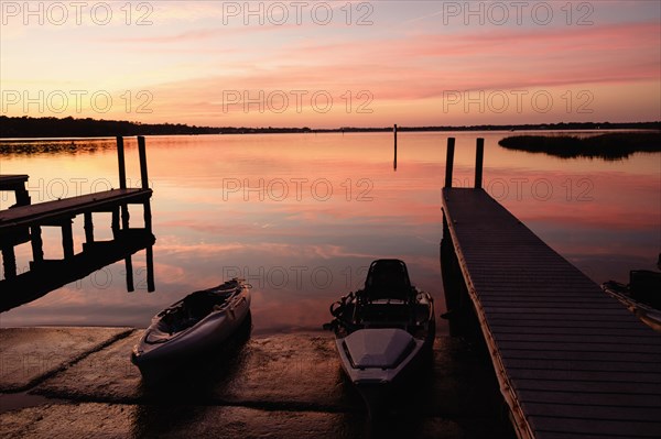 Kayaks near dock at sunset