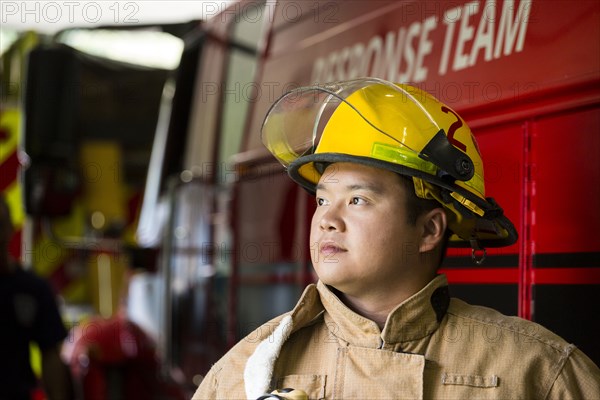 Chinese fireman standing near fire truck