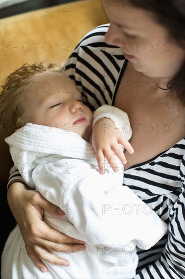 Caucasian mother holding baby son