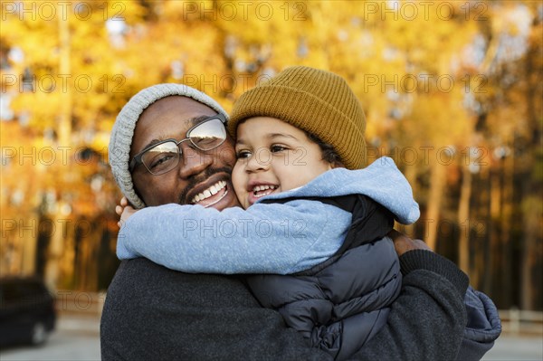 Father and son hugging in park