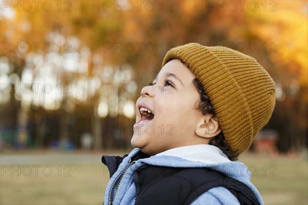 Mixed Race boy laughing in park