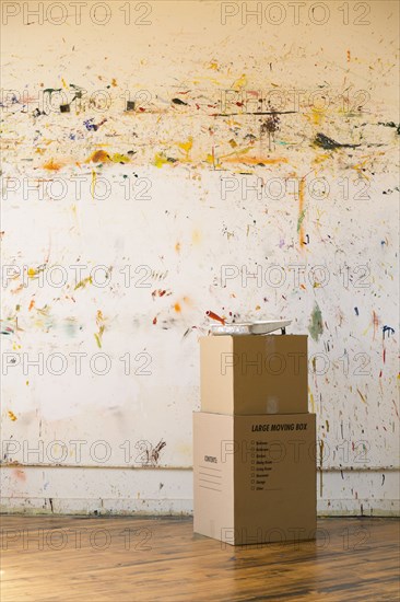 Paint splattered on wall near cardboard boxes