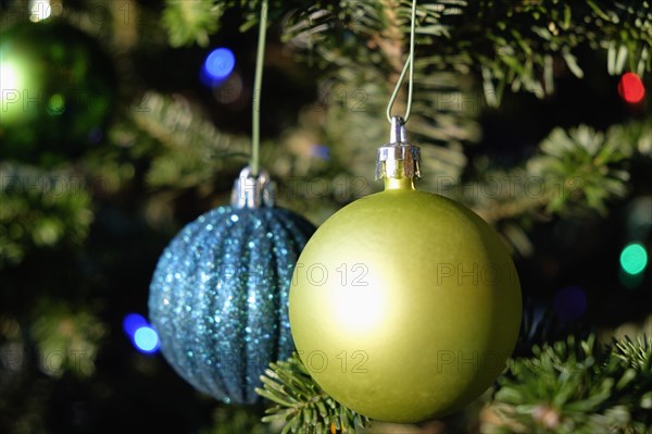 Blue and green ornaments hanging on Christmas tree