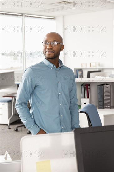 Smiling African American man standing in office