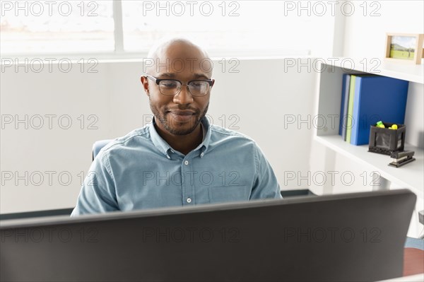 African American man using computer in office