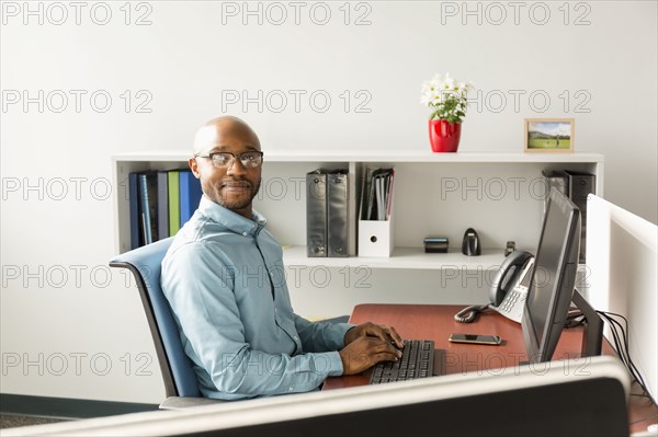 African American man using computer in office