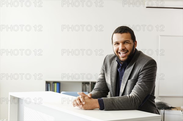 Mixed Race man smiling in office