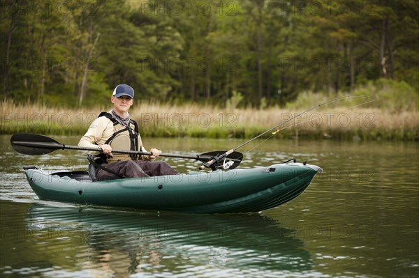 Caucasian man fishing on kayak