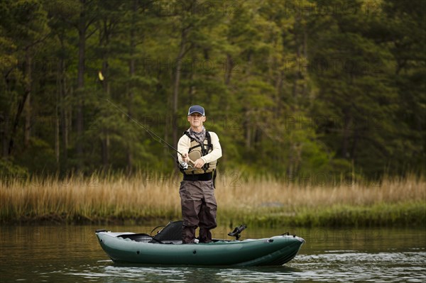 Caucasian man fishing on kayak