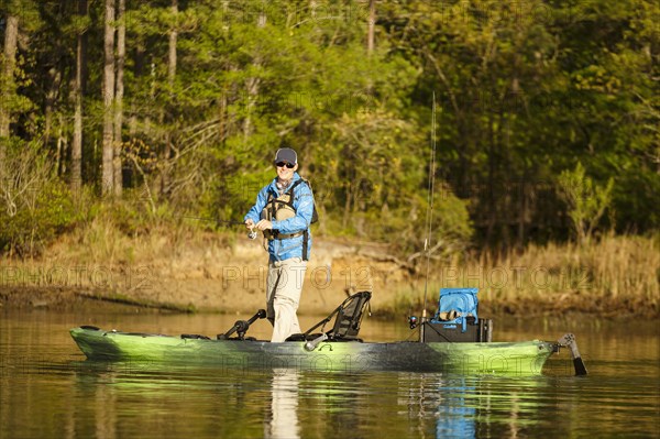 Caucasian man fishing on kayak