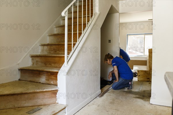 Native American woman remodeling floor