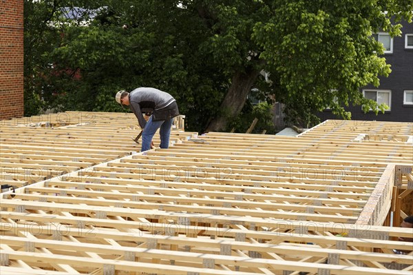 Distant Caucasian man hammering frame at construction site