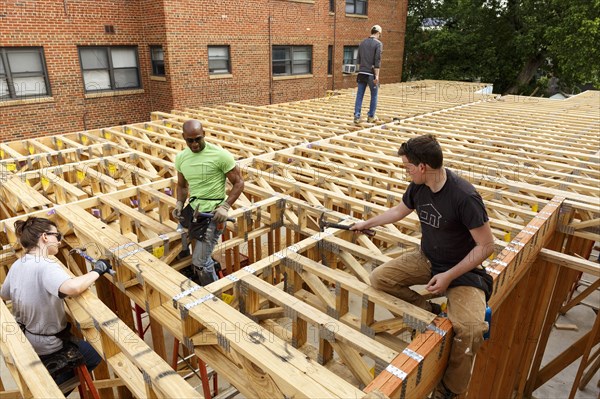 Volunteers hammering at construction site