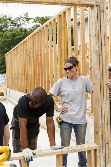 Volunteers holding frame at construction site