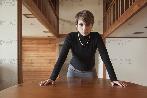 Caucasian woman leaning on table