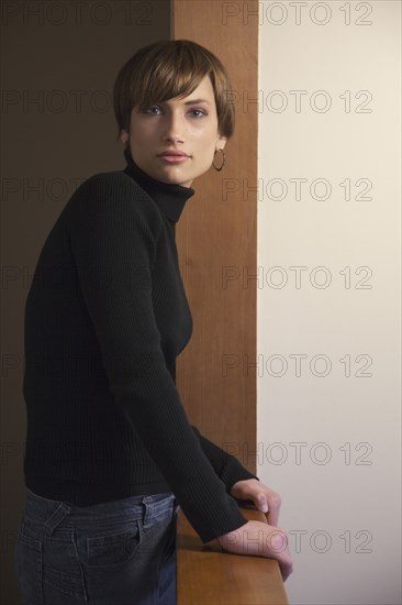 Caucasian woman standing at banister