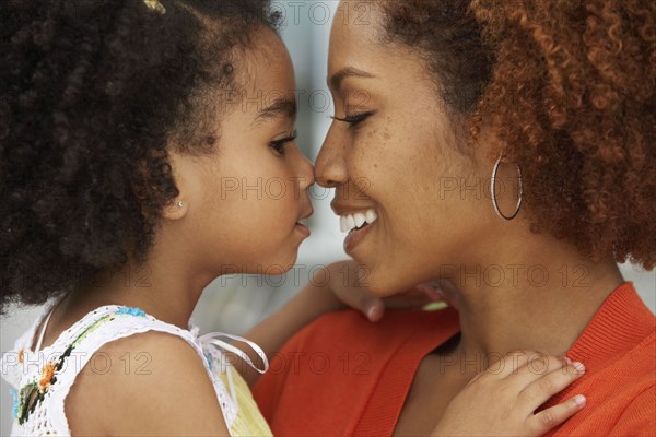 Mother and daughter touching noses