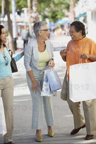 Group of middle-aged women with shopping bags