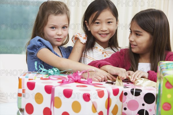 Group of young girls opening gifts