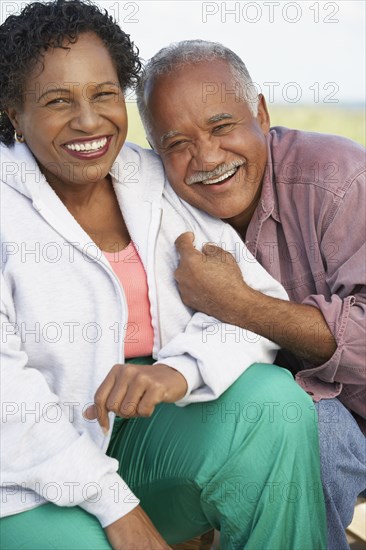 Senior couple smiling and hugging outdoors