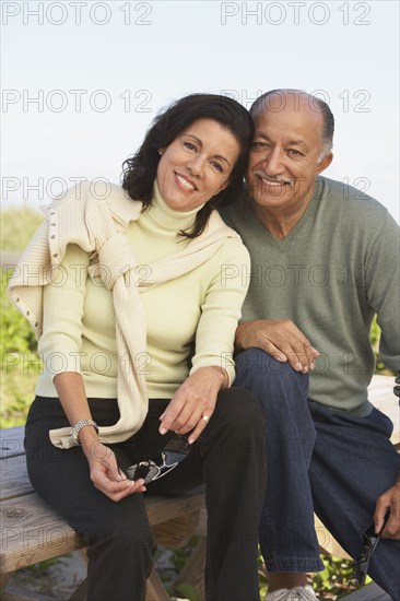 Senior couple hugging and smiling outdoors