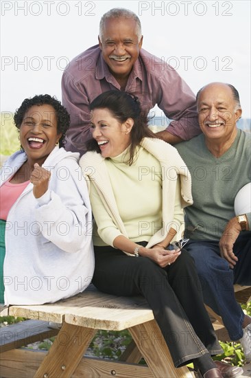 Two senior couples laughing outdoors