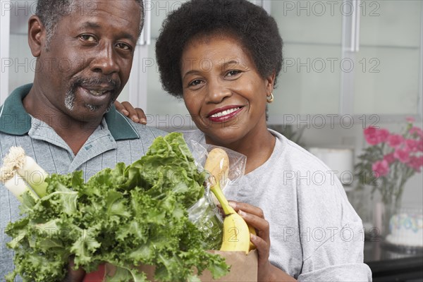 Middle-aged African American couple with groceries