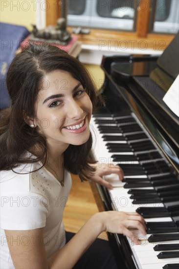 Young Hispanic woman playing piano