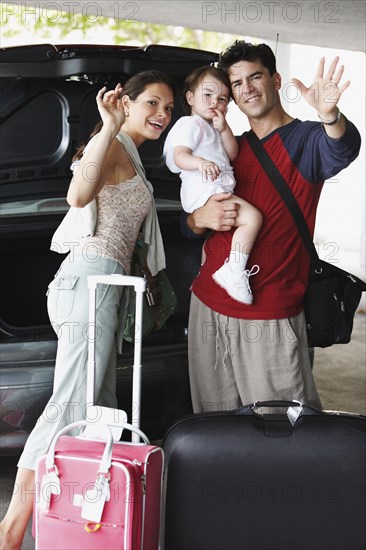 Hispanic family going on trip and waving