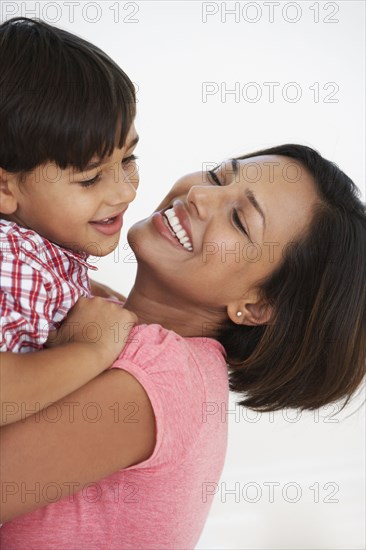 Indian mother and son hugging