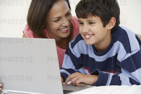 Indian mother and son using laptop