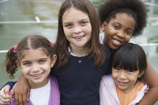 Multi-ethnic children hugging