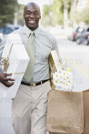 African man carrying gifts