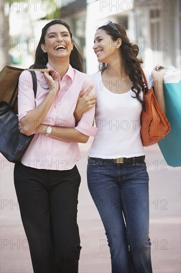 Two Hispanic women with shopping bags