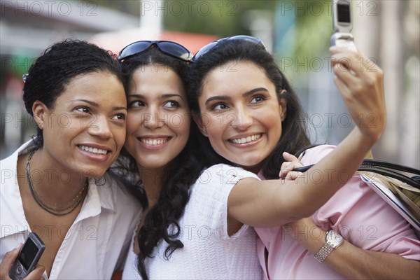 Multi-ethnic friends taking own photograph