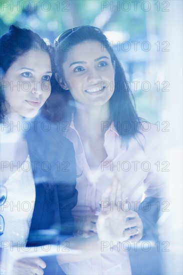 Two Hispanic woman window shopping