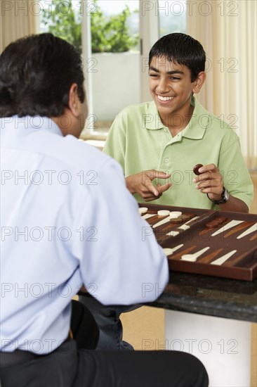 Middle Eastern father and son playing game