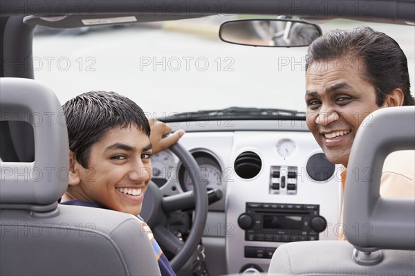 Middle Eastern father and son in new car