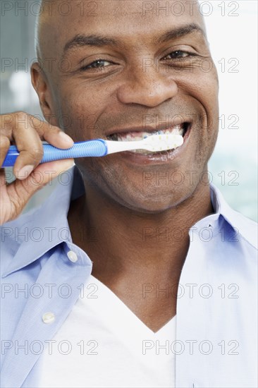 African American man brushing teeth